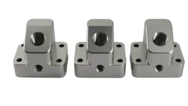 CNC-machined stainless steel blocks with precision bores for life sciences instrumentation.