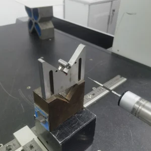 Coordinate measuring machine inspecting a machined part