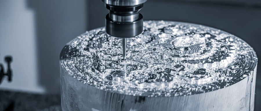 CNC milling machine cutting an aluminum workpiece with coolant visible