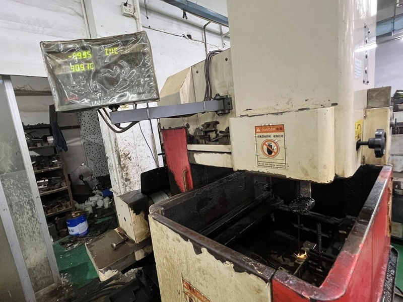 Small Hole EDM machine creating a tiny deep hole using a narrow tubular electrode.