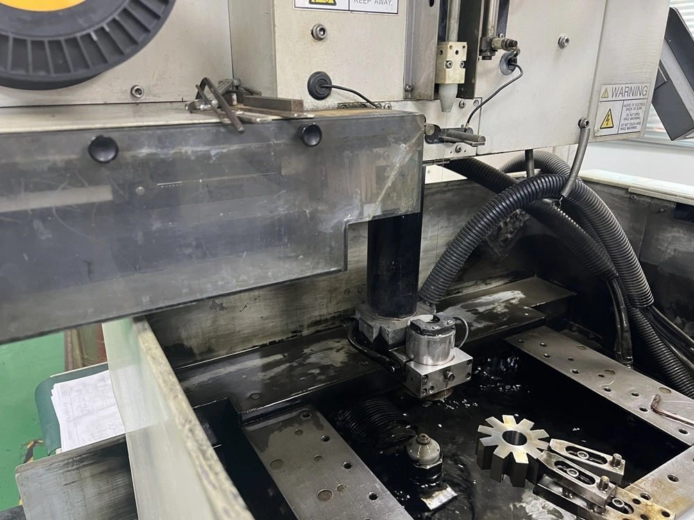 Wire EDM machine cutting metal with a thin brass wire and controlled sparks.