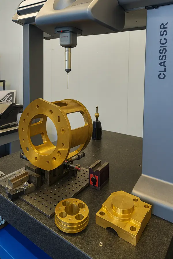 CMM probe scanning a bronze component on the measurement table