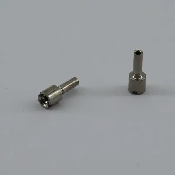 Kovar micro part showing 0.1 mm thin walls and tiny holes