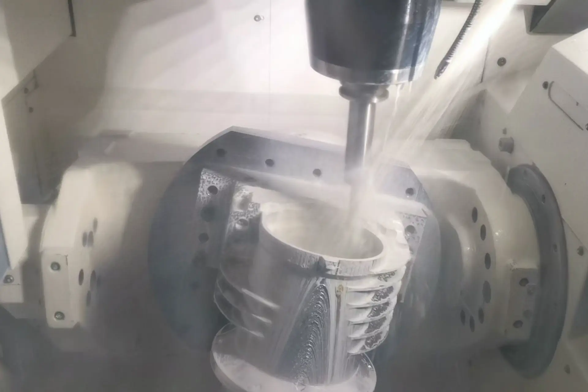 CNC machining titanium part with coolant and specialized tooling in action