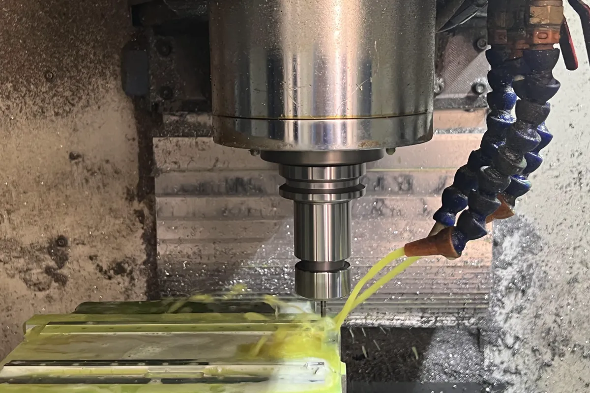 CNC machine cutting metal part — precision machining