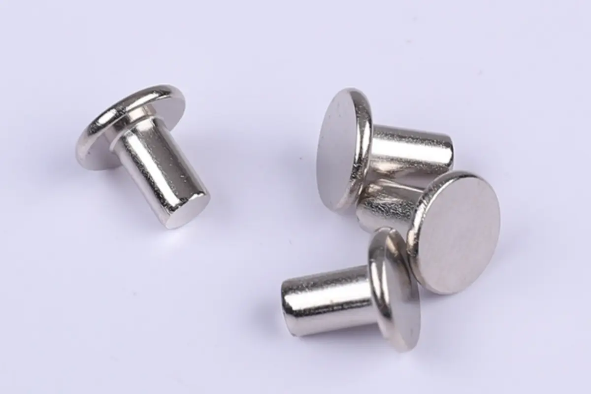 solid rivets forged into metal joints with hammer and bucking bar for structural strength