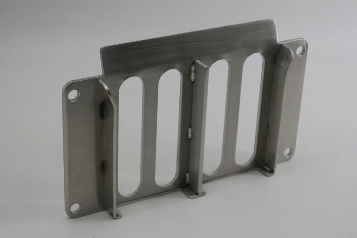 welder applying tack welds to hold large steel plates in place before final welding