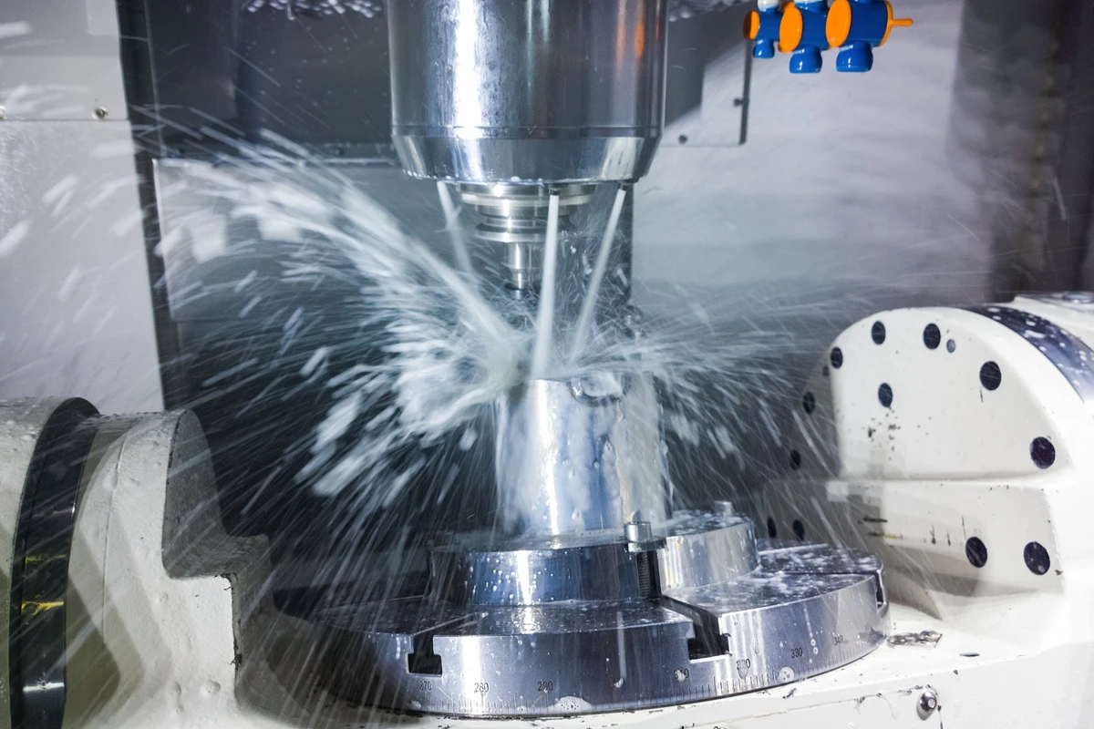  5-axis CNC machine cutting a solid metal billet to precise tolerances