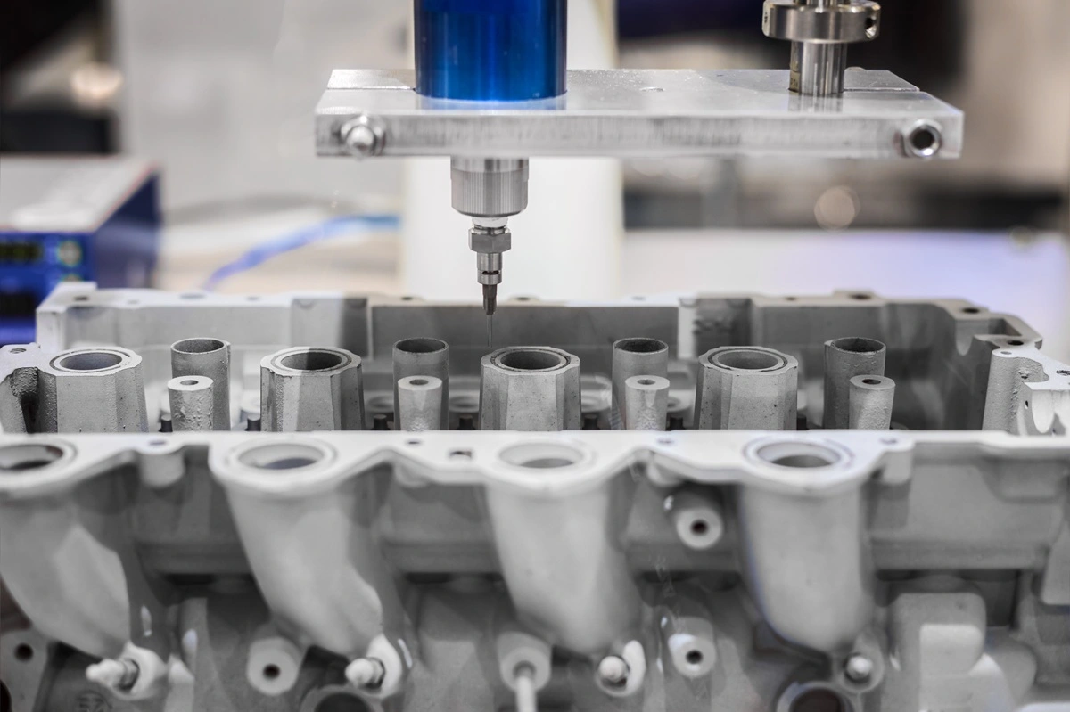 Five-axis CNC machine finishing a cast metal part, showing precision machining