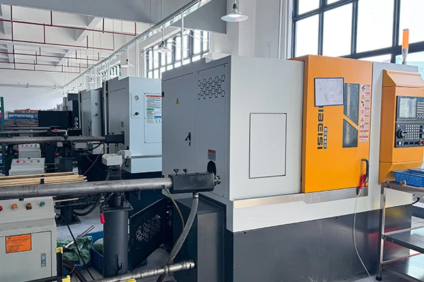 Automated lights-out manufacturing cell featuring a CNC Swiss machine and bar feeder for continuous high-volume production