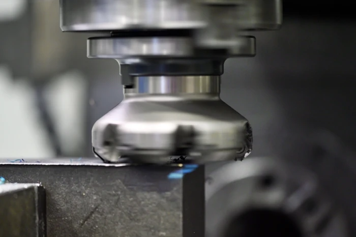 CNC milling machine cutting an Invar 36 nickel-iron alloy part for ultra-precision manufacturing
