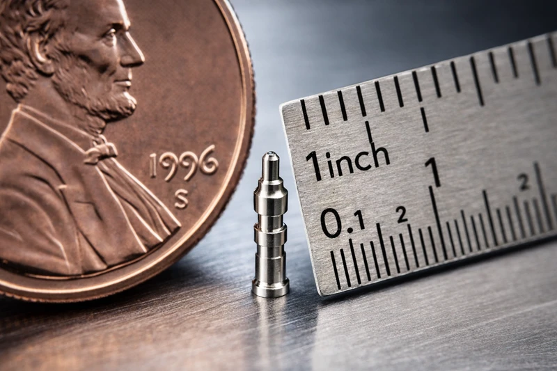 Extremely small and precise Swiss machined part manufactured by Rollyu Precision showing tight tolerances and smooth surface finish