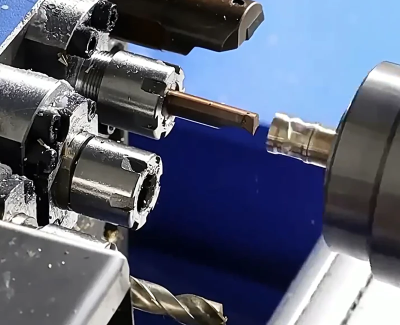 Precision Swiss machining process cutting a small metal component on a CNC lathe