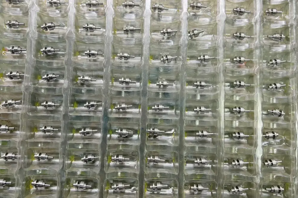 Clean and finished Swiss machined medical parts safely packaged in custom protective trays