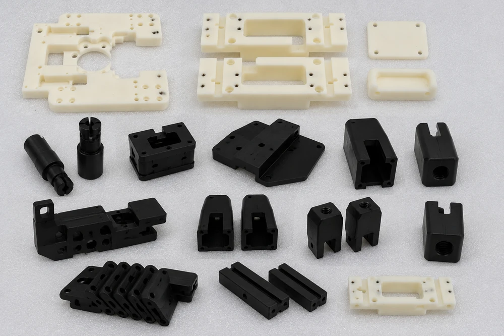 variety of complex white (Natural) and black Delrin parts