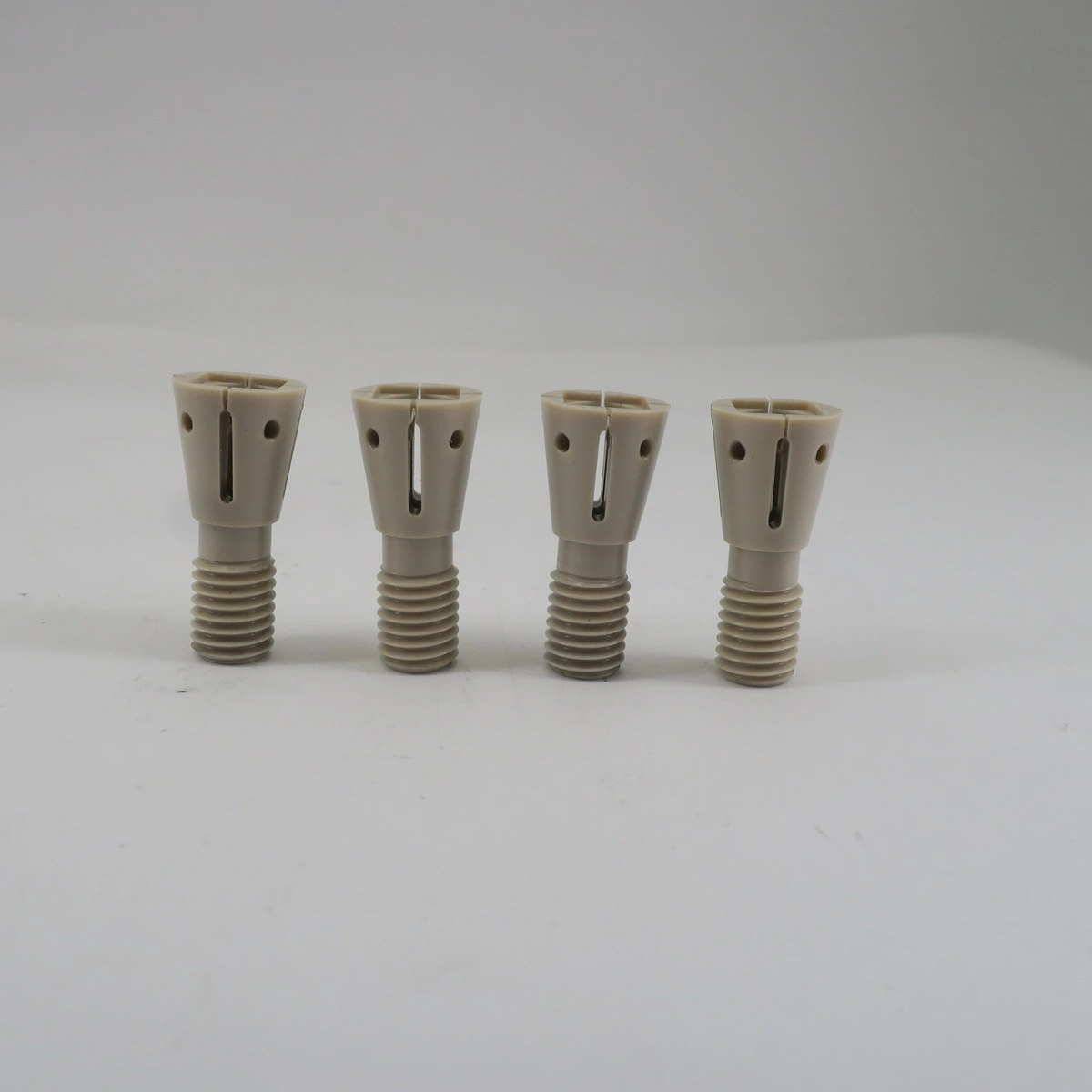 Precision CNC machined PEEK medical components with threaded and slotted features
