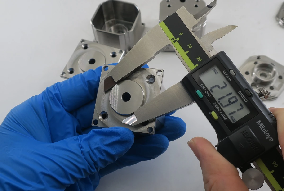 The uploaded inspection image shows a digital caliper, not a CMM