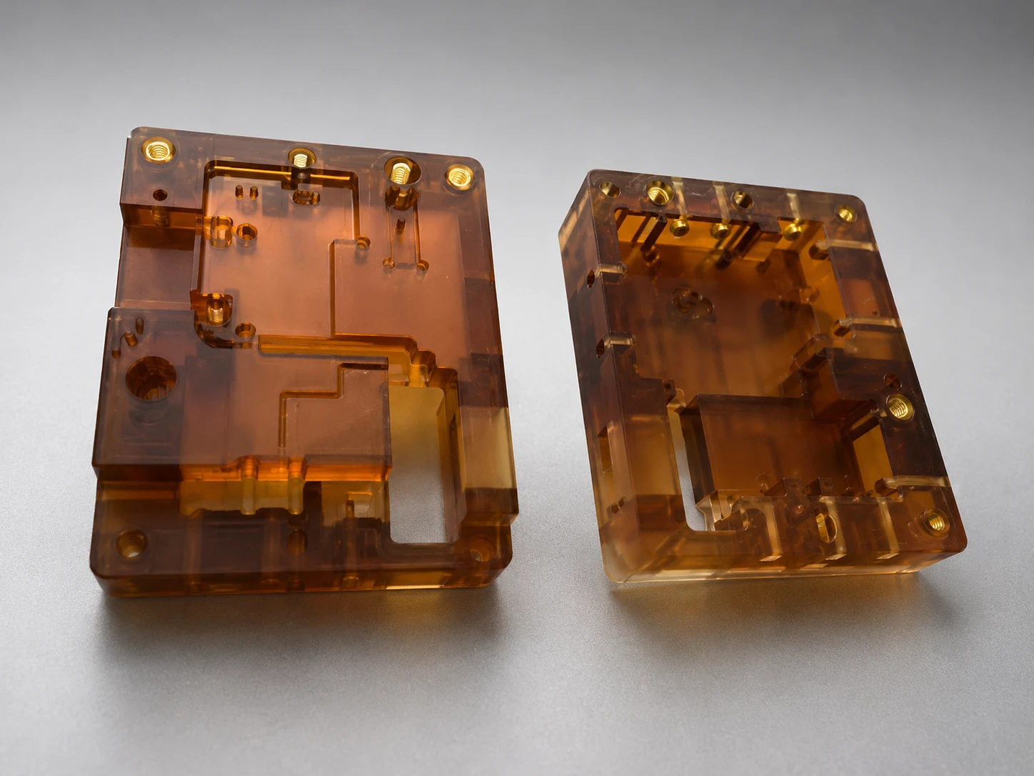 CNC machined amber PEI housings with pockets and threaded inserts