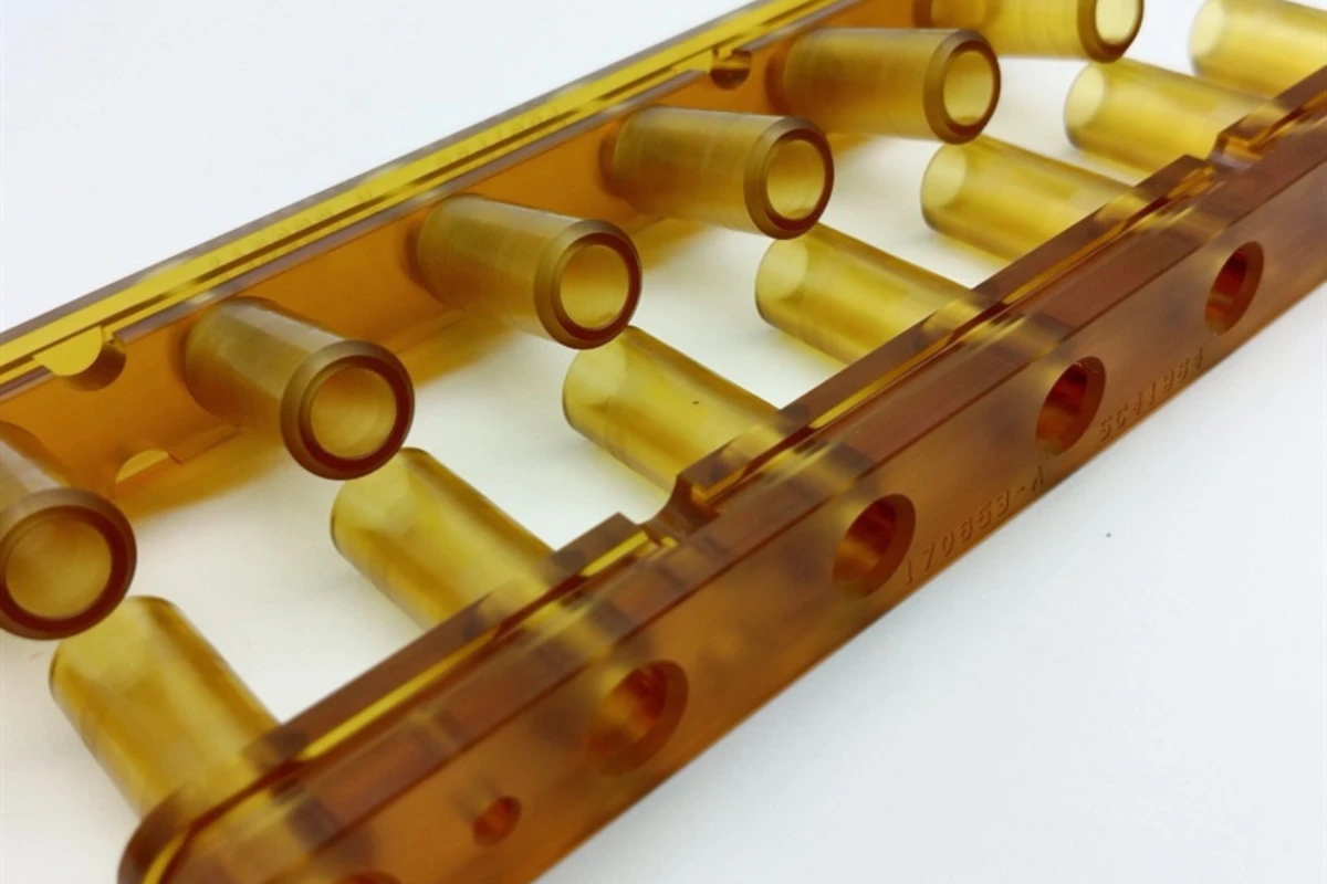 Complex CNC machined amber PEI component with multiple bores and channels