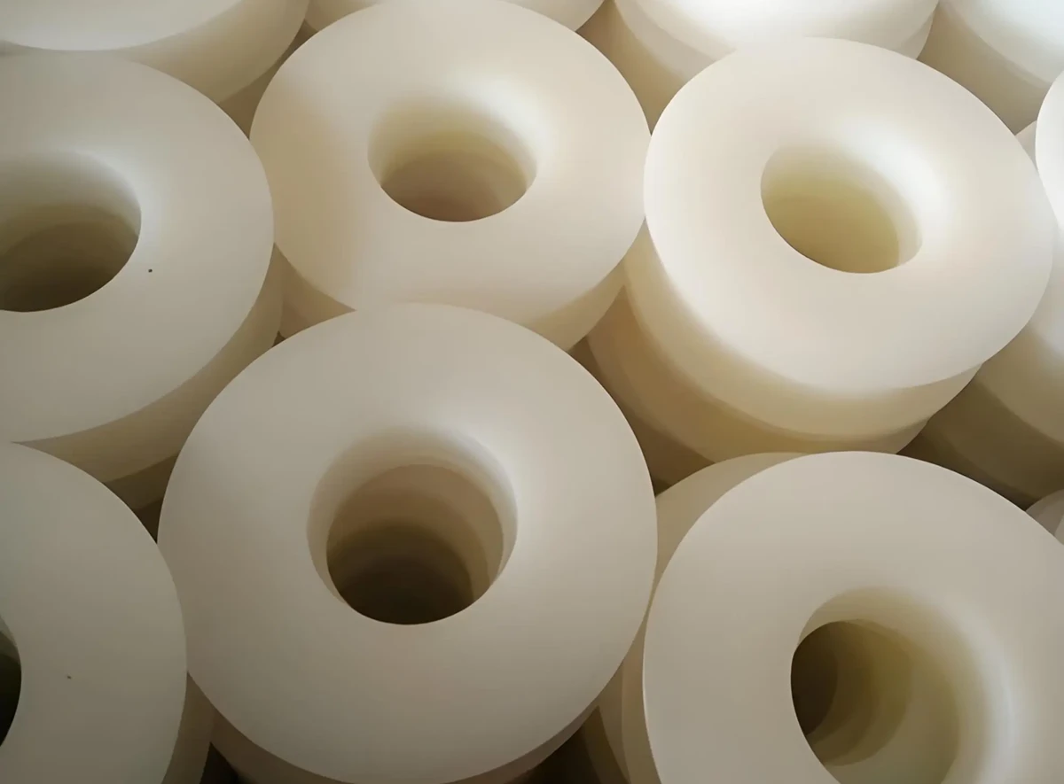 Custom CNC machined UHMW polyethylene parts with large precision bores and smooth turned faces