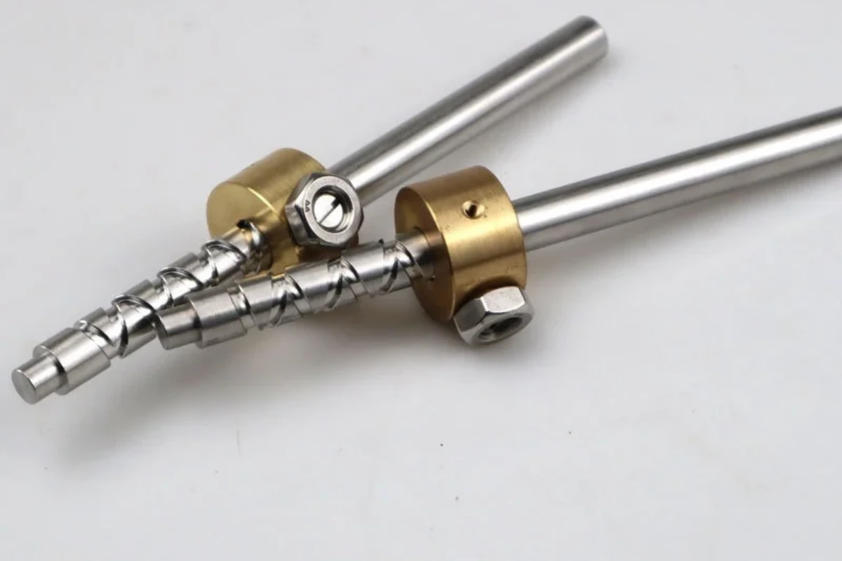 Custom machined threaded fastener assemblies in steel and brass colored components on a clean surface