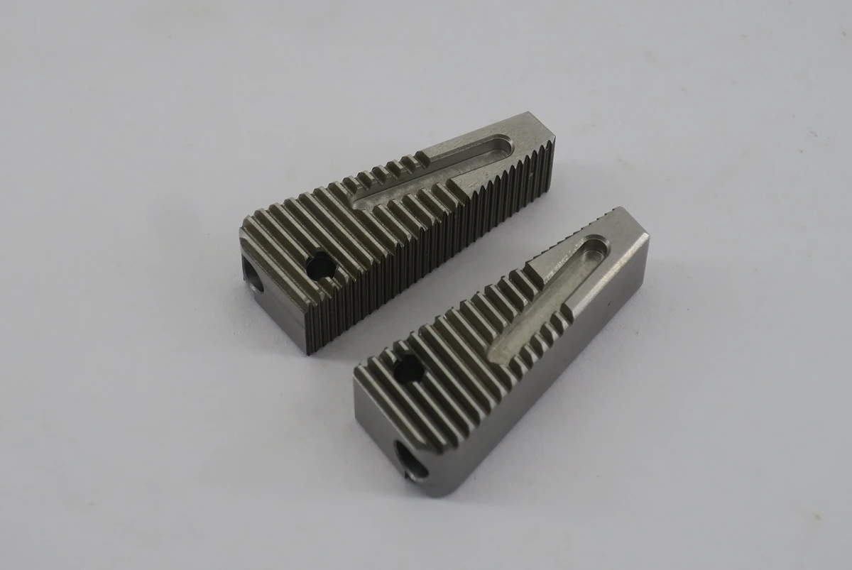 Hardened 55 HRC 440C stainless steel grip wedges with sharp functional rack teeth