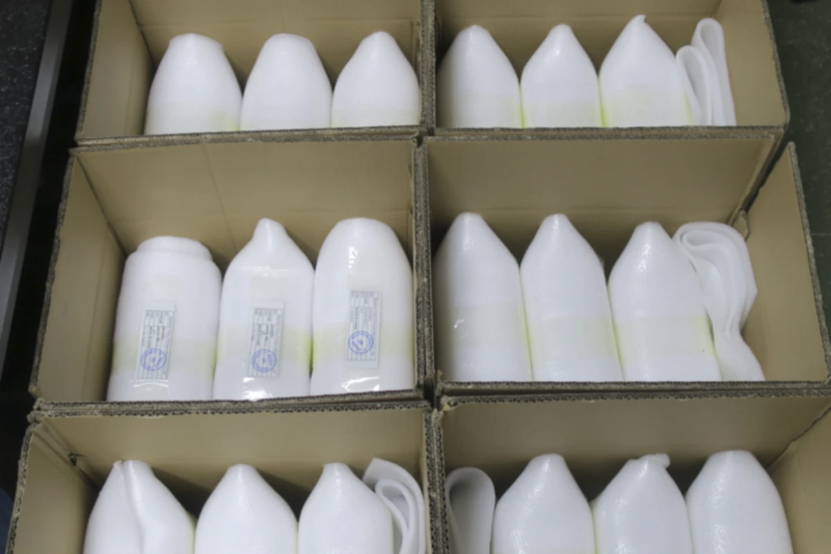Individually foam wrapped CNC machined parts separated into carton compartments to control movement during transportation