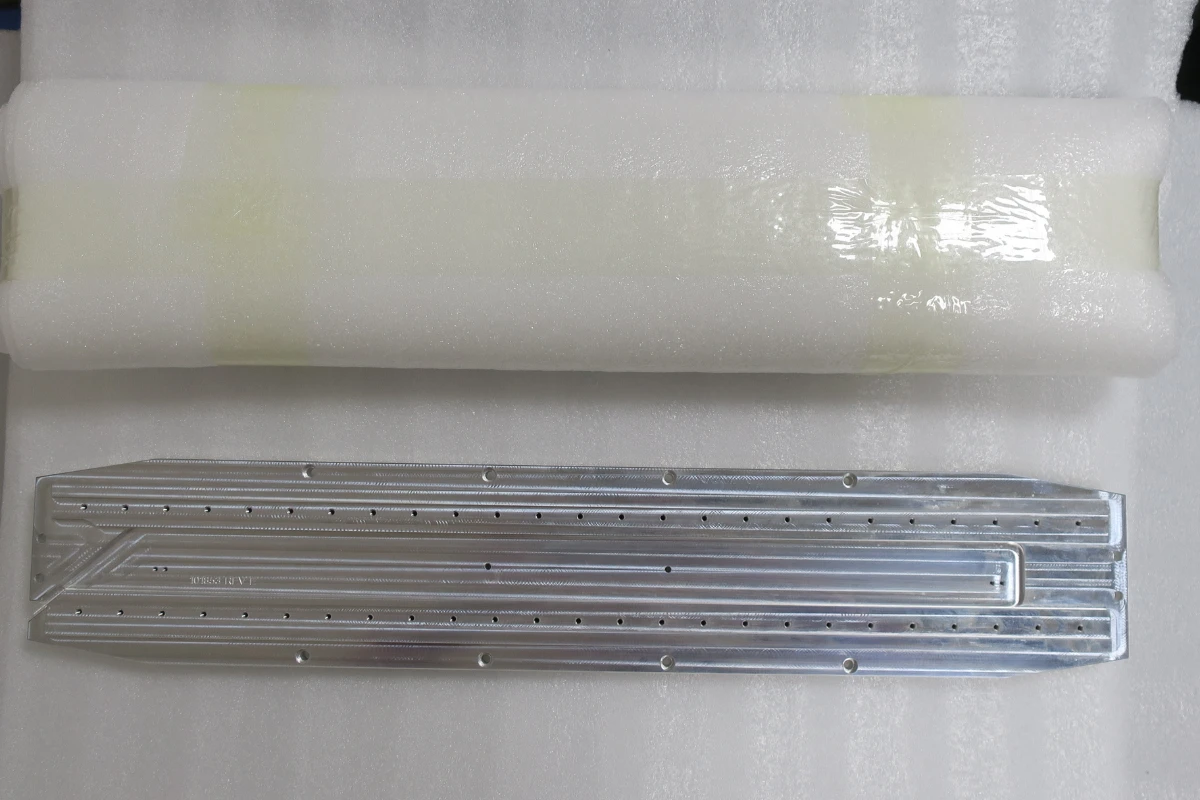 Large machined aluminum plate protected with full surface foam padding for storage and transportation