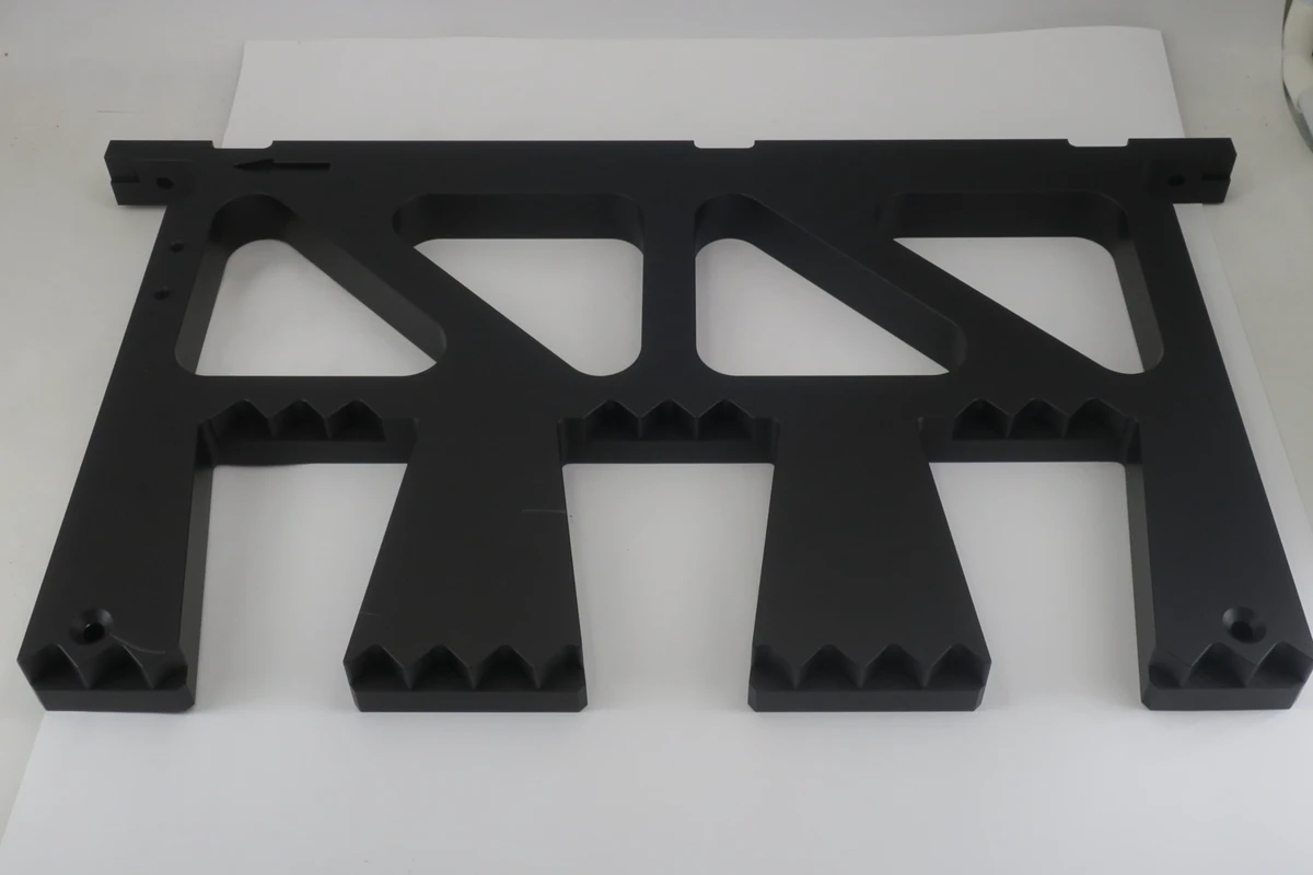 Large matte black anodized aluminum CNC frame with a uniform low gloss surface finish