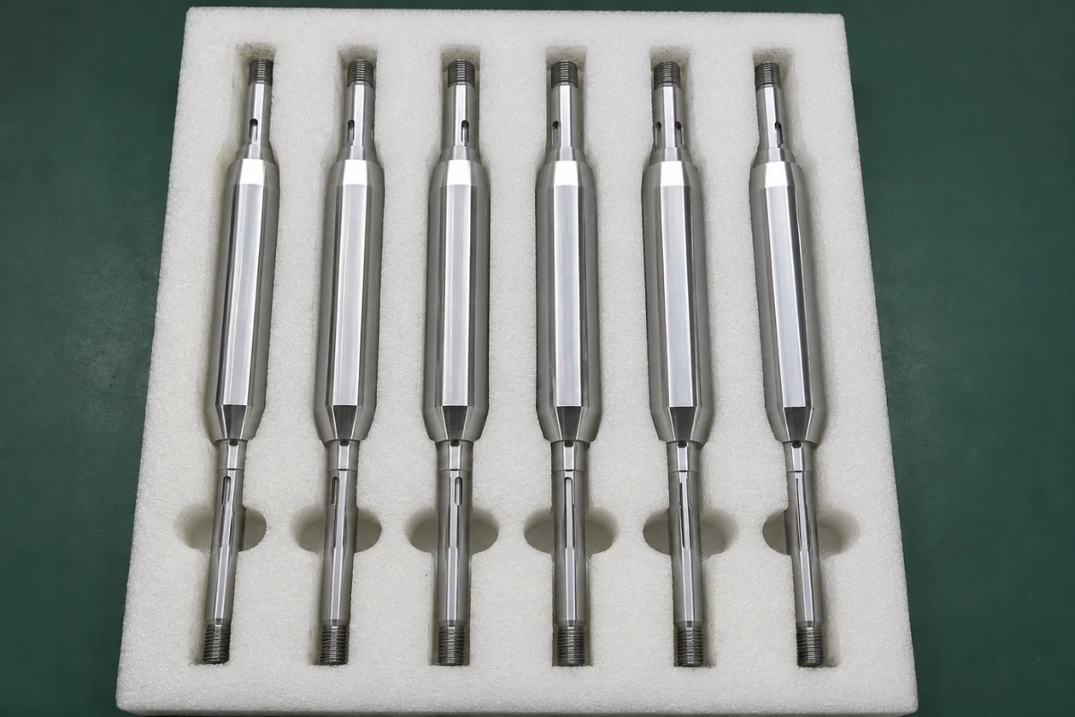 Long precision turned shafts secured in custom foam channels to reduce movement and bending risk during shipping
