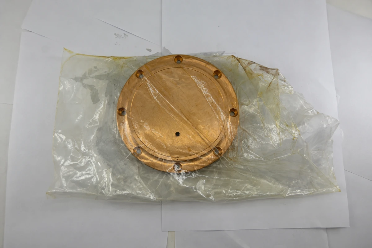 Machined bearing bronze component protected in barrier packaging for storage and transport