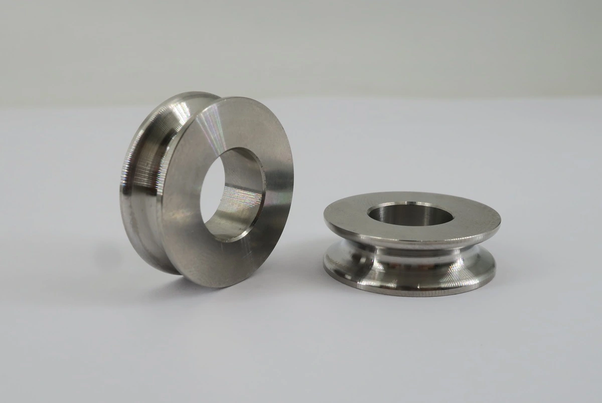 Machined stainless steel rollers with controlled bores and formed track profiles.