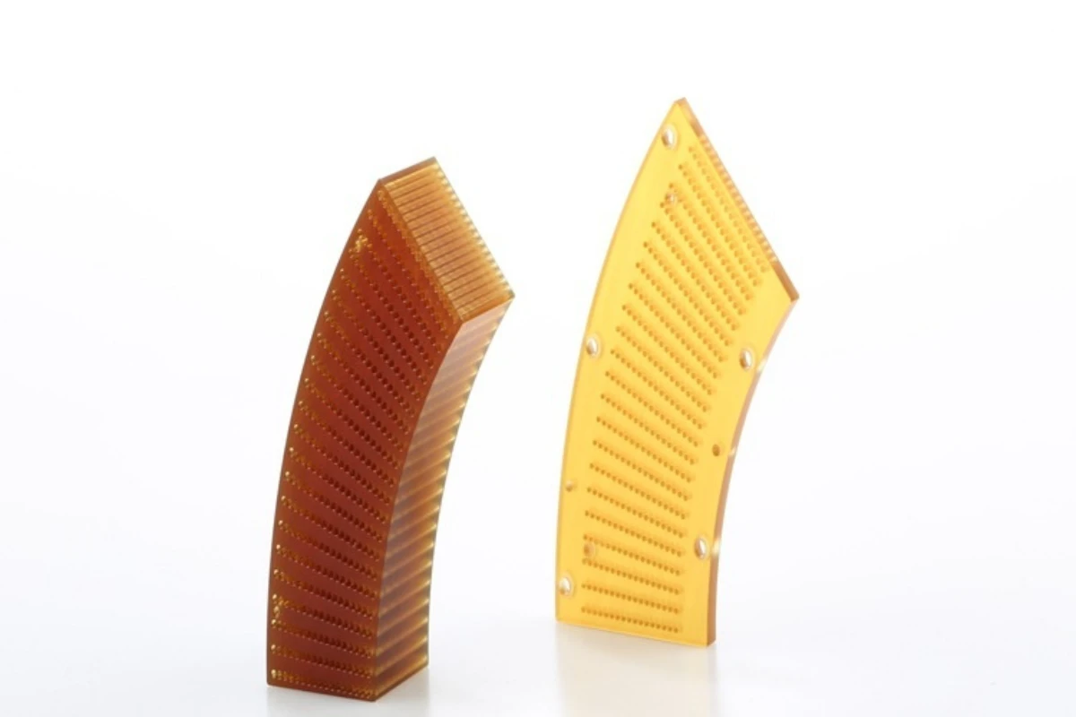 PEI CNC machined curved component with precision micro hole pattern.