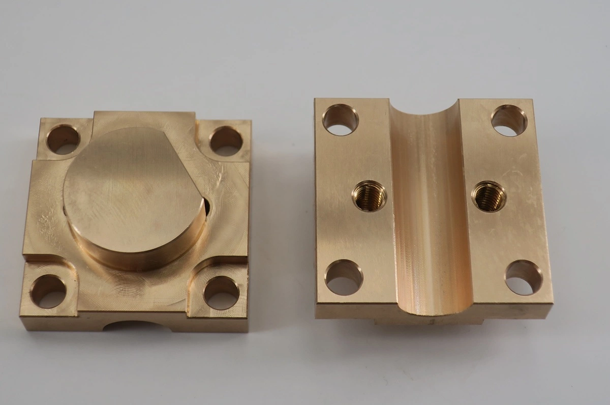 Phosphor bronze machined blocks with precision bores and threaded features