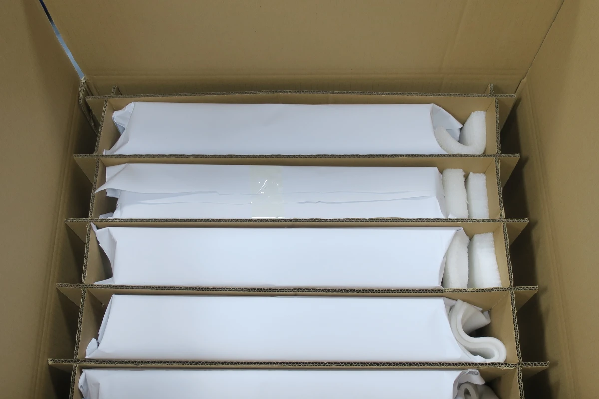 Sheet metal enclosures individually wrapped and separated with corrugated dividers and foam inside a shipping carton