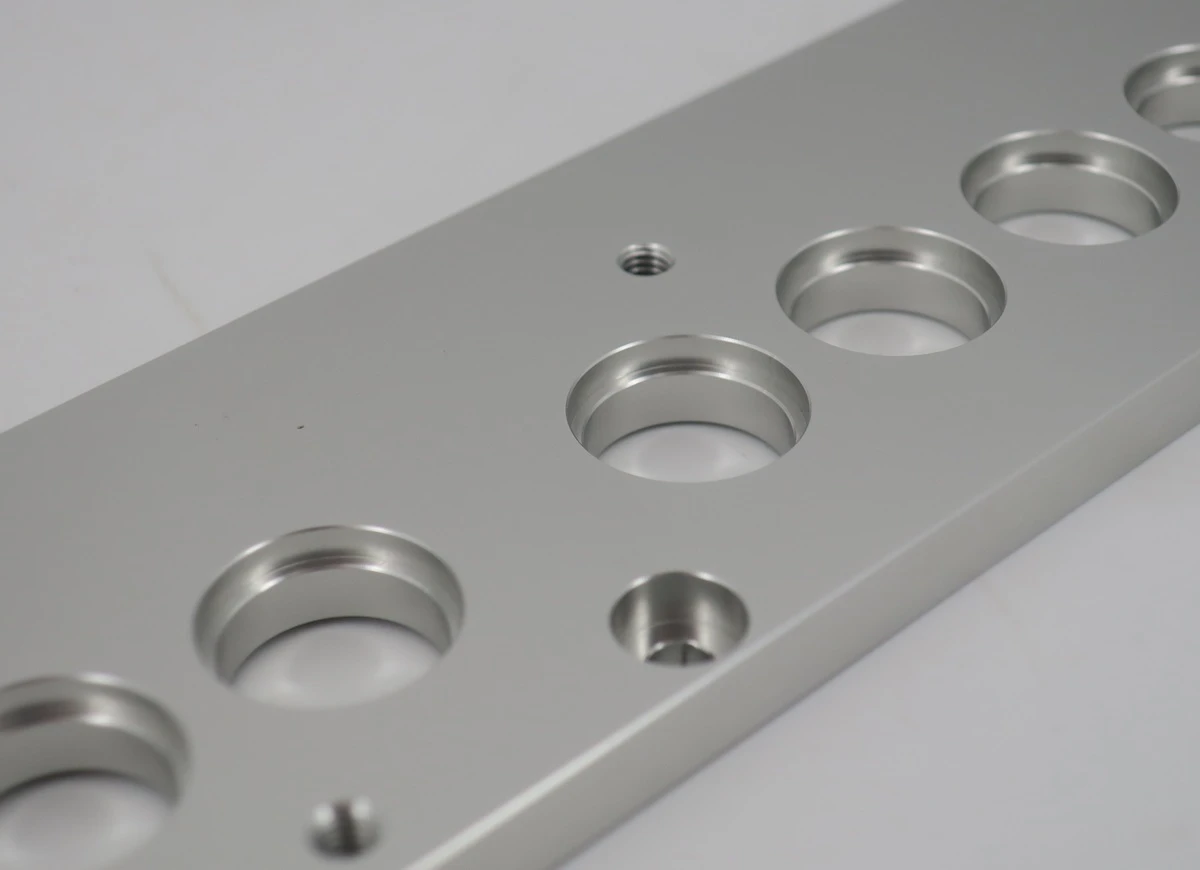 clear anodized aluminum CNC plate with precision bores  counterbores and threaded holes